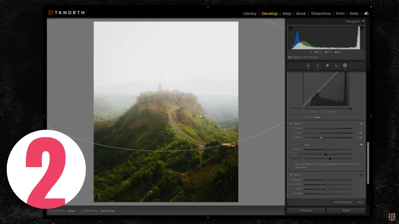 Lightroom radial gradient adding soft atmospheric haze over a hilltop village, local clarity and dehaze adjustments.
